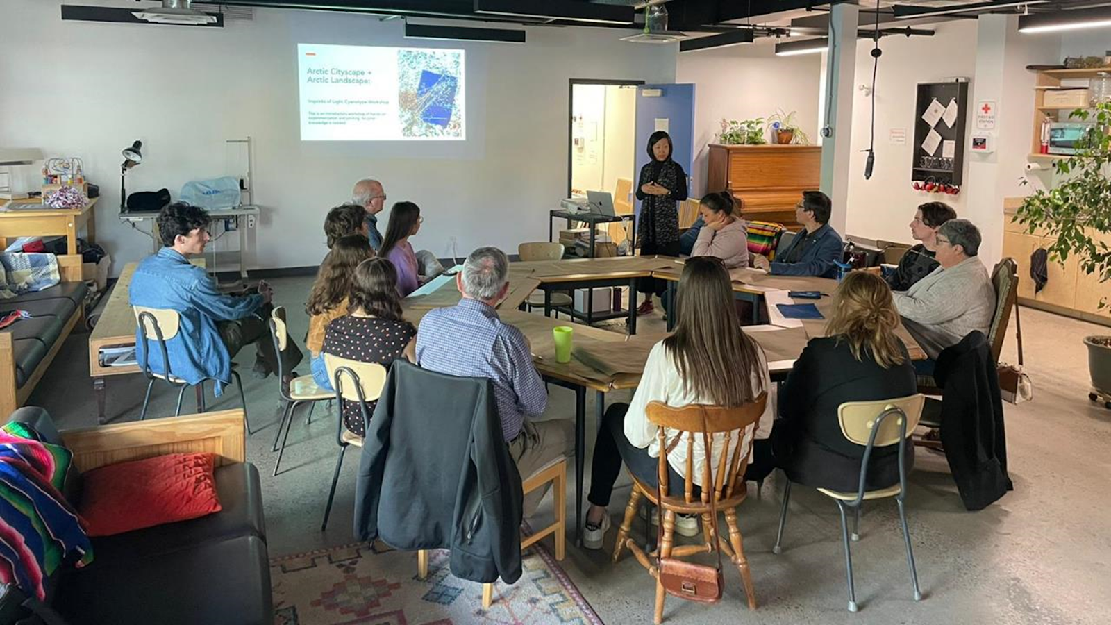 students meet with artist Beili Liu in a classroom