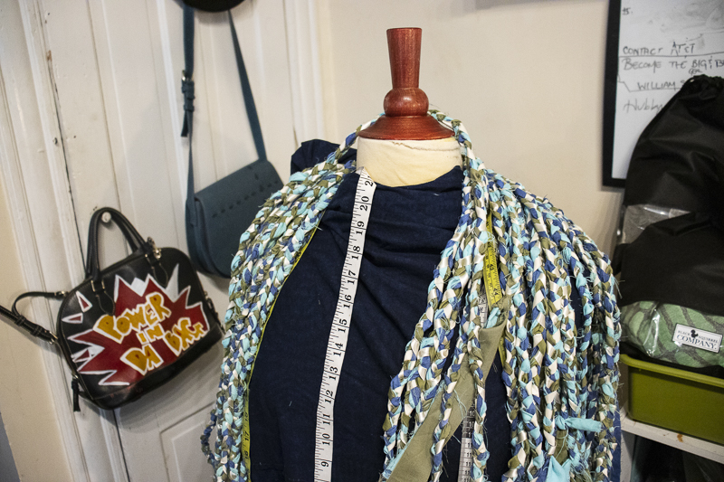 Graduation Cords Assembly Blue, green and beige graduation cords around a mannequin with a tape measure