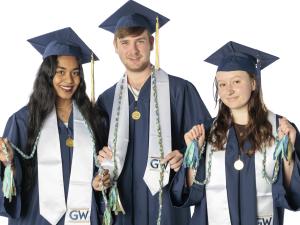 Three GW Students in graduation regalia with Sustainability Minor graduation cords