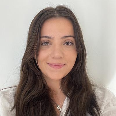 a woman with brown hair and a white shirt