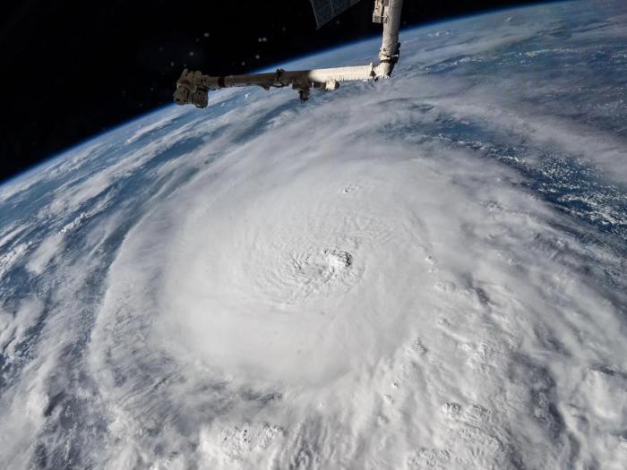 Aerial view of earth with clouds and a sateltie