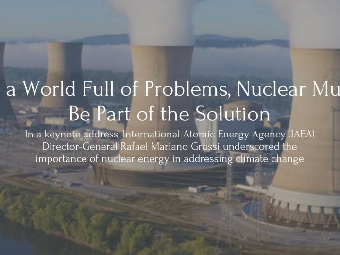 Text: In a World Full of Problems, Nuclear Must Be Part of the Solution. In a keynote address, International Atomic Energy Agency (IAEA) Director-General Rafael Mariano Grossi underscored the importance of nuclear energy in addressing climate change. Behind the text sits an image of 4 nuclear reactors