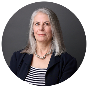 Donna Attanasio a woman with a navy blazer and striped shirt