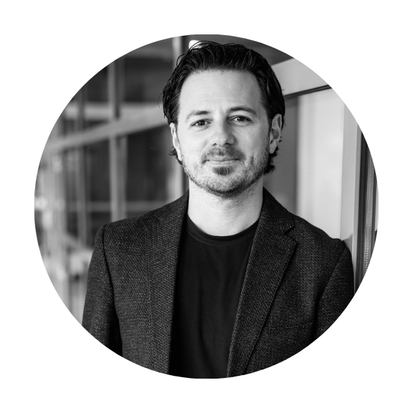 Dan Reed a black and white photo of a man in a dark blazer with dark hair