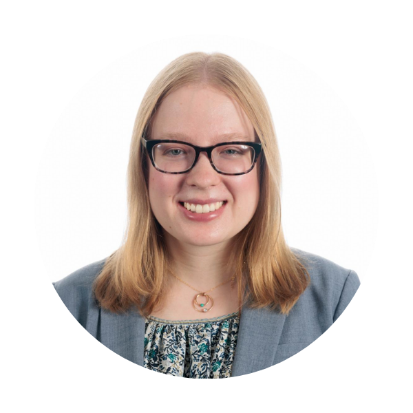 Erin Carlin a woman with blonde hair and glasses in a blue grey blazer