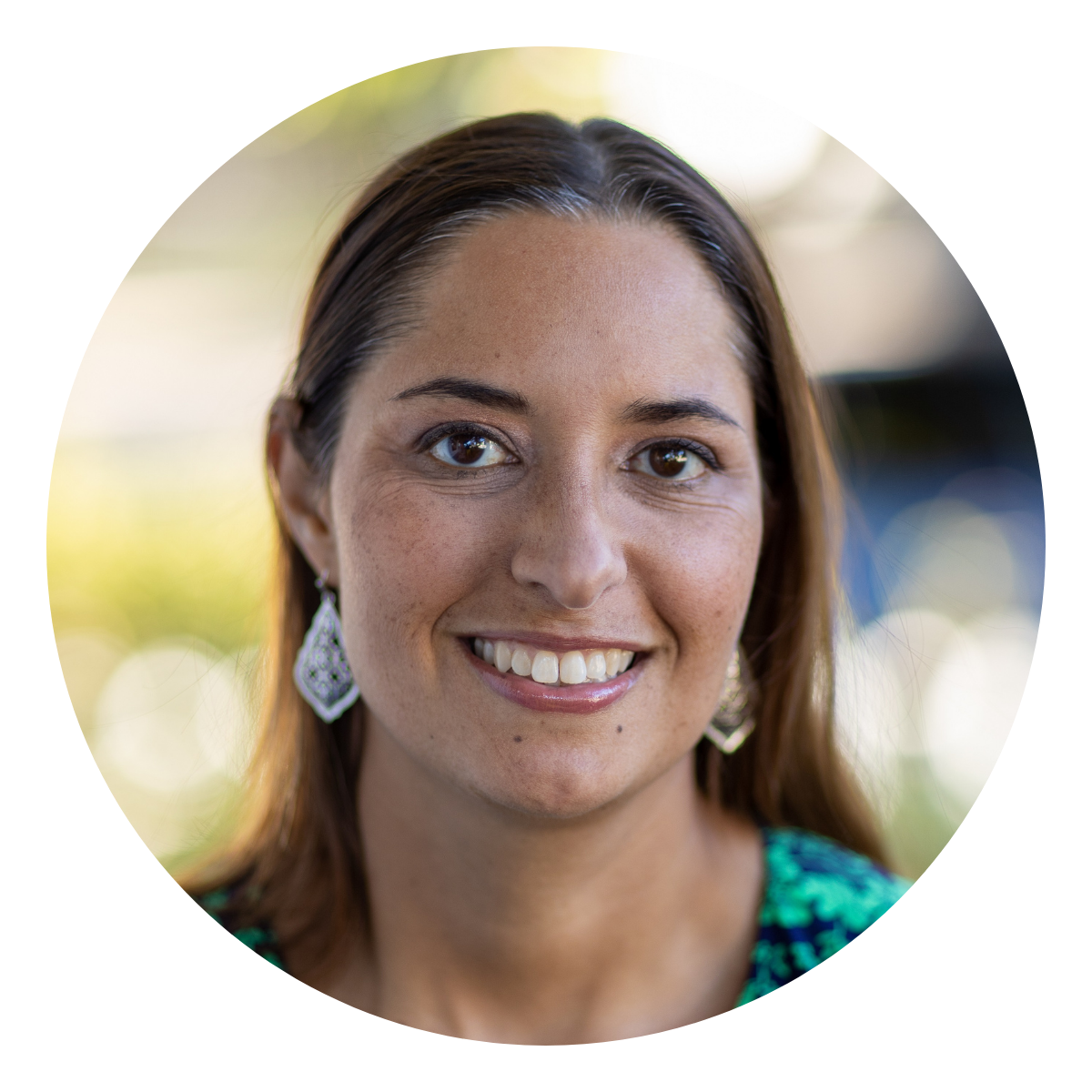 Katherine Garcia A woman with dark brown hair and earrings outside