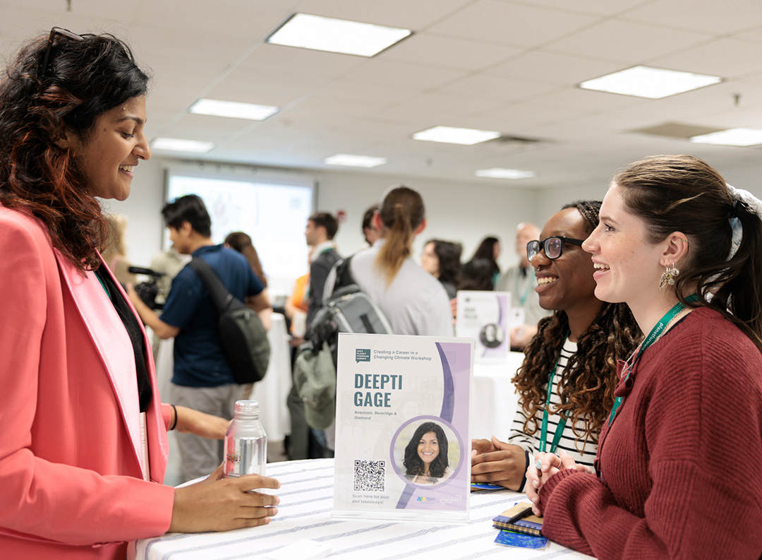 students speak to business representatives at a career fair