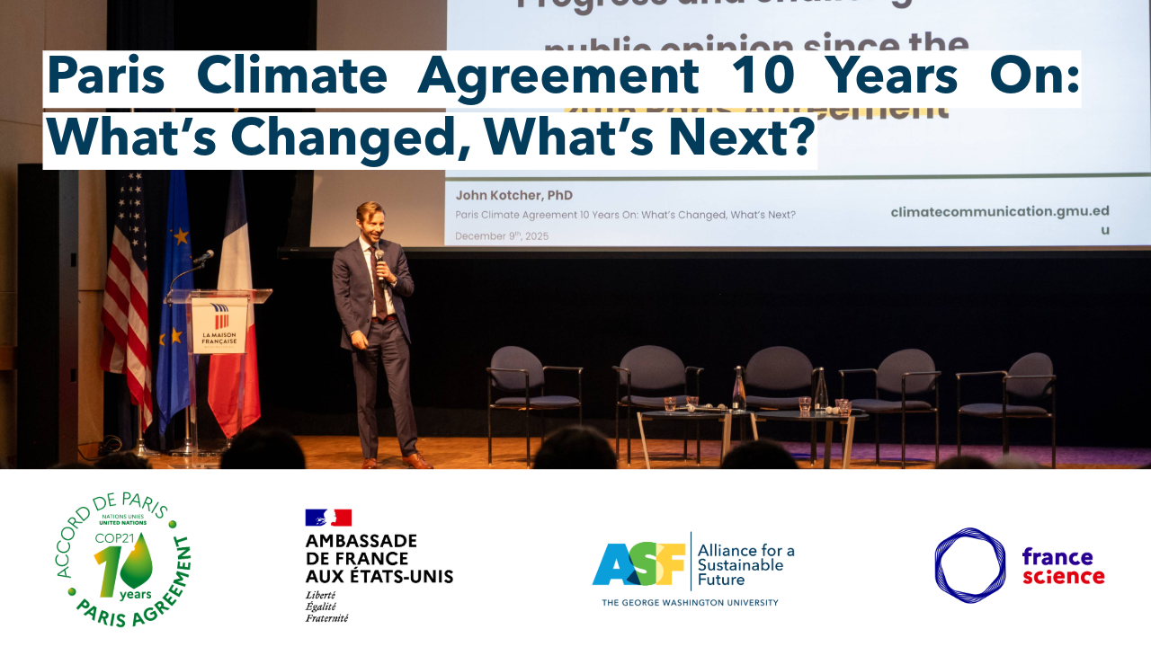 a man in a suit stands on stage