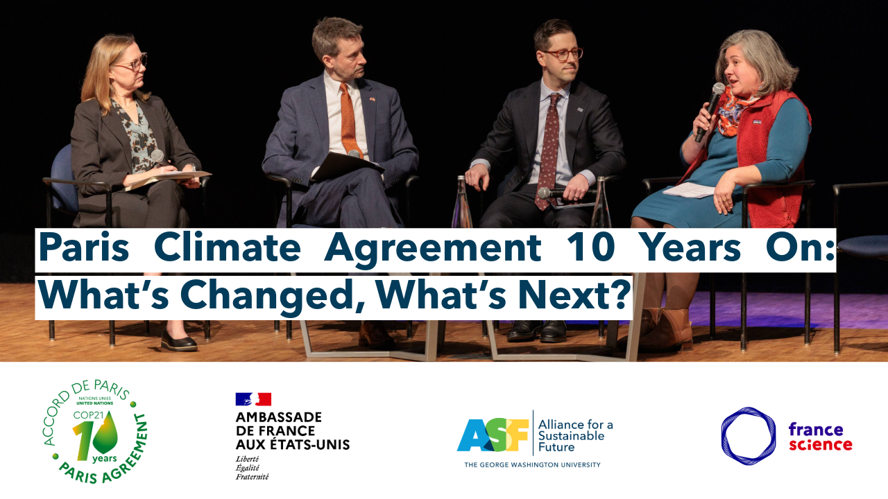 a group of four people on stage one holds a microphone